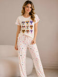 Pijama Perritos Gafas Crema para mujer, camiseta manga corta y pantalón largo a juego.